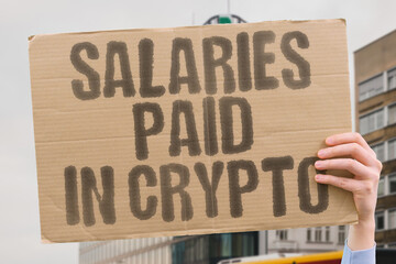 Salaries paid in crypto. A protest banner warns of unstable remuneration in digital coins, replacing consistent earnings. BLOCKCHAIN. UNCERTAINTY. INFLATION. SPECULATION. FINTECH. RISK. LABOR.