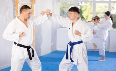 Obraz premium Athletes sparring during karate classes in the gym
