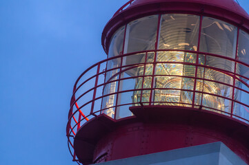 Red lighthouse beacon glowing at twilight on Madeira Island at Ponta do Pargo