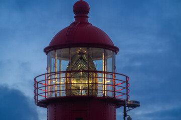 Lighthouse close-up with lantern lit against blue evening sky, Madeira Island at Ponta do Pargo