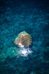 Aerial View of Ocean Rock and Turquoise Water Splash