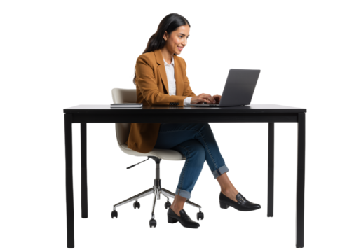 Smiling professional woman confidently working on her laptop at a modern desk, embodying productivity and digital engagement in a bright, clean studio environment.