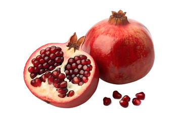 Fresh ripe whole pomegranate fruit with another cut in half revealing its juicy red seeds, scattered arils isolated on a pure white background.