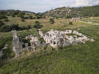 Aerial view of roman bath ruins at patara near the modestus arch, limestone walls, spring hills, kas district in antalya, ancient lycian ambience, authentic travel location on the coast
