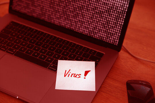 Virus, warning sign, laptop infected. Binary code, bits and bytes. Note, message, cyber attack, threat, network security, hacked, computer crime.