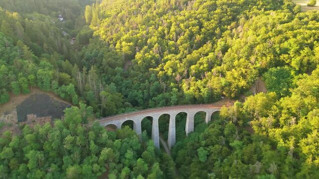 Discover the stunning Zampach railway bridge, the highest stone bridge in Czechia, nestled in lush greenery. Marvel at its architecture as it spans the valley.
