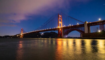 Obraz premium Night view of a magnificent bridge over water