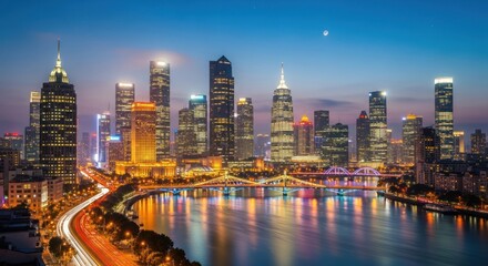 Fototapeta premium Bright Cityscape Skyline at Night with River Reflections and Blue Twilight Sky
