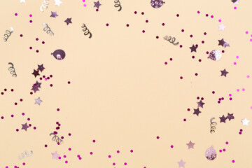 Party pink confetti on color background, top view