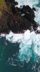 Coastal cliffs meeting turquoise waves