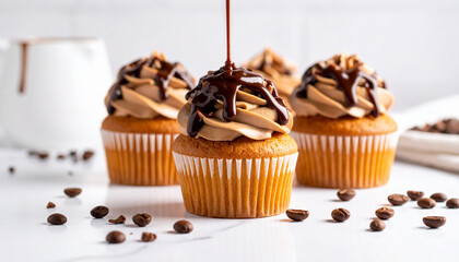 cupcakes with coffee cream poured with chocolate on a light background.