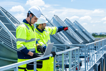 Industrial engineer teamwork working maintenance building exterior cooling systems. Male technician...