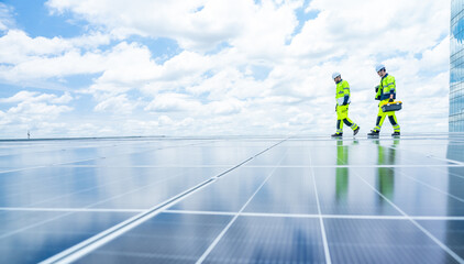 Solar cell, electricity alternative renewable clean energy for environmental conservation, sustainability technology. Male engineer maintaining solar panel system on construction site building rooftop