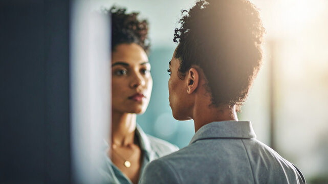 self-reflection, woman, mirror, reflection, contemplation, confidence, self-care, portrait, curly hair, natural light, focused, thoughtful, empowerment, mental health, emotional, peaceful, inner self,