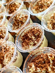 Tiramisu Dessert Cups CloseUp of CocoaDusted Creamy Italian Treats in Clear Plastic Containers.