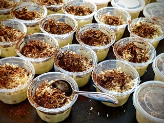 Tiramisu Dessert Cups Creamy Layers with Cocoa Dust and Grated Cheese.