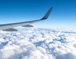 Obraz premium Soaring Above the Clouds: A captivating view from an aircraft window, the wings slice through a sea of fluffy white clouds, mirroring the vast expanse of a clear blue sky. 