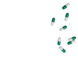 Green and white medication capsules
