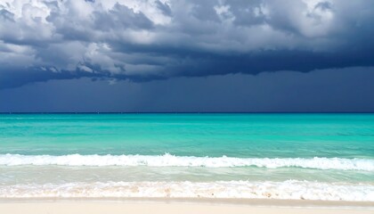 Fototapeta premium Tropical beach with stormy sky, and ocean waves.