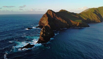 Naklejka premium Dramatic aerial view of a rugged volcanic island coastline, waves crashing against dark cliffs.