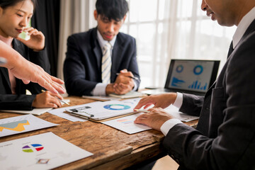 Business people analyzing charts and graphs during a meeting