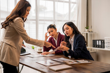 Businesswomen having a serious discussion about paperwork showing negative results