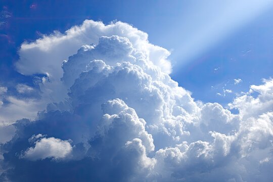 Vast, fluffy clouds against a vibrant blue sky, sunbeams piercing through - Powered by Adobe