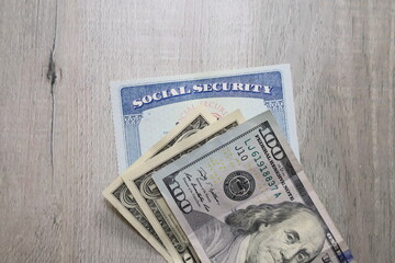 Social security card a US bills. Income at retirement concept.