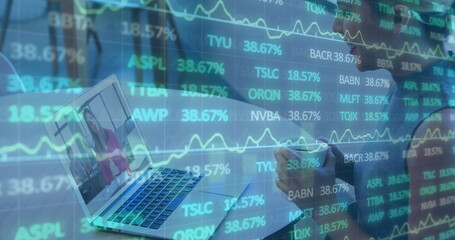 Woman in striped top writing notes at desk, with laptop showing colleague, overlaid charts
