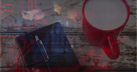Displaying red mug holding frothy latte on rustic tabletop, with notebook and pen, copy space © vectorfusionart