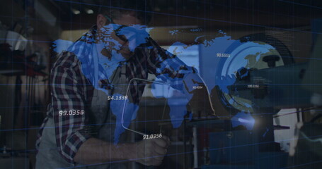 Machinist in apron adjusting cutting tool on lathe at machine shop, with world map overlay