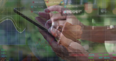 Collaborating businesswomen analyzing charts on touchscreen tablet at garden, with stock tickers