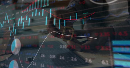 Technician hands adjusting smartwatch strap in workshop, with cutting mat and stock market overlays