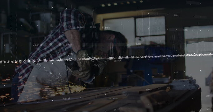 Grinding beam with angle grinder in workshop, craftsman wearing apron leather gloves safety glasses