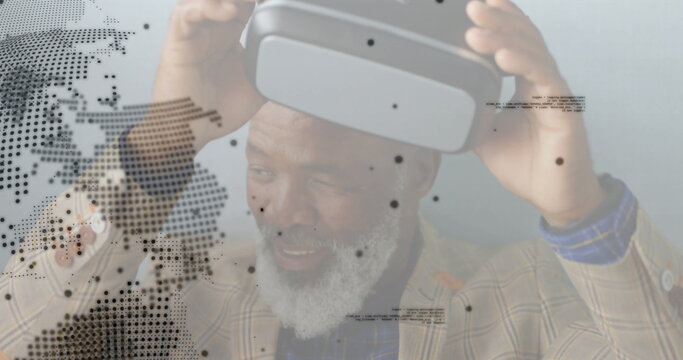 Lowering VR headset senior executive wearing plaid blazer in studio, displaying world map overlays - Powered by Adobe