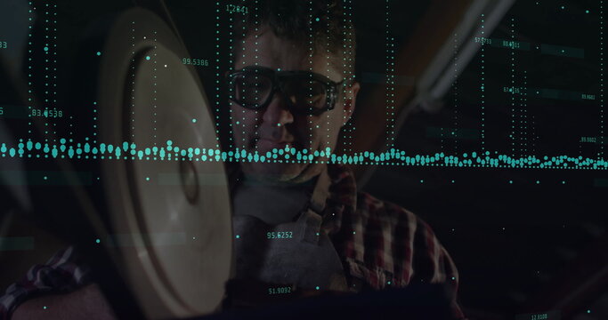 Machinist wearing goggles operating bench grinder in machine shop, with sparks and data overlay - Powered by Adobe