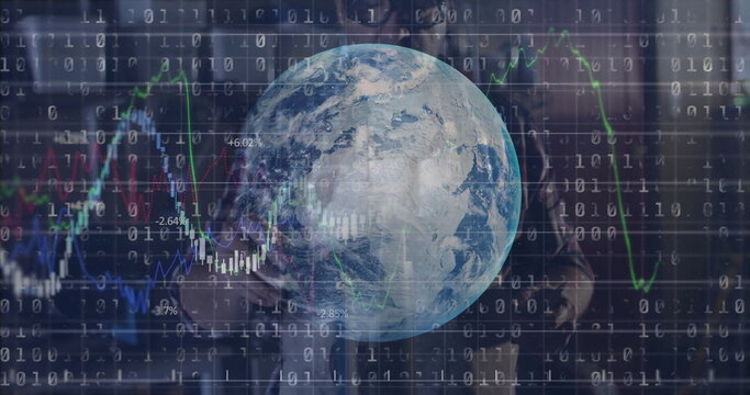 Standing man in suit, tie overseeing Earth globe in data grid, with binary code and candlesticks