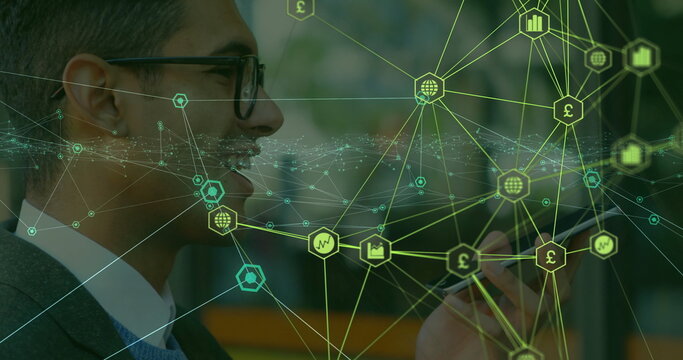 Grinning businessman holding smartphone in office corridor, with digital overlay, copy space - Powered by Adobe