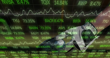 Naklejka premium Stepping soccer cleat with shin guard on sports field turf, with stock ticker overlay, copy space