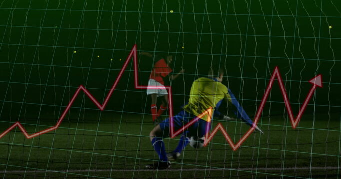 Diving yellow goalie saving ball from red jersey player at night field with net analytics overlay