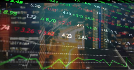 Displaying financial data overlay over city junction at dusk, with numbers green red arrows graph
