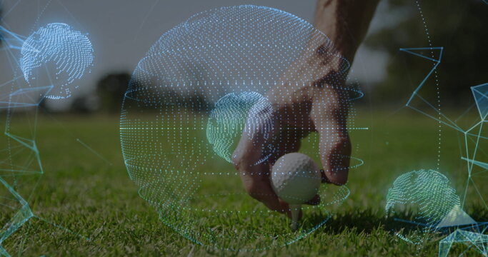 Sportswear-clad male hand placing white golf ball onto wooden tee on fairway with digital spheres