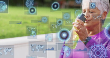 Drinking woman in purple top on park bench holding water bottle, showing data overlays, copy space