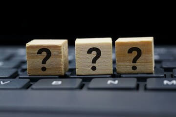 Wooden Block with Question Mark isolated on Computer Keyboard. Concept, ideas, and inspiration.