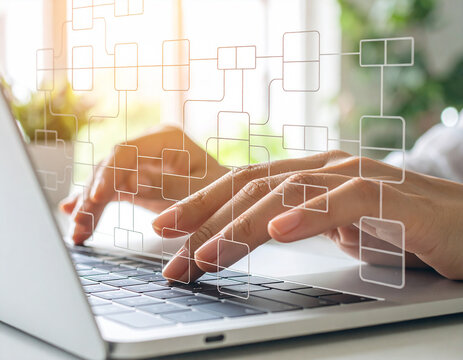 Typing on laptop. Data flow diagram. Process decomposition and data flow analysis. Engineer using laptop computer to manage data processing system.