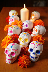 Fototapeta premium Decorated Sugar Skulls with Marigold Flowers and Candles Background — Día de muertos