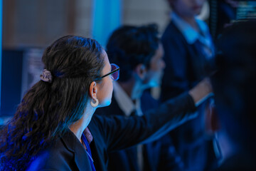 A diverse audience of professionals at a tech conference, attentively watching a presentation. A concept for business seminars, industry events, and professional skill development.