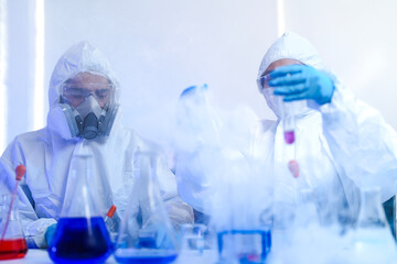 A diverse team of scientists collaborates in a high-tech biotech lab. A senior researcher mentors...