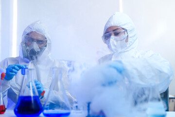 A diverse team of scientists collaborates in a high-tech biotech lab. A senior researcher mentors...