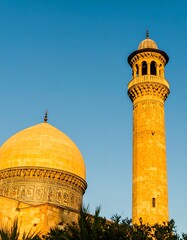 Fototapeta premium Golden mosque dome and minaret at sunrise